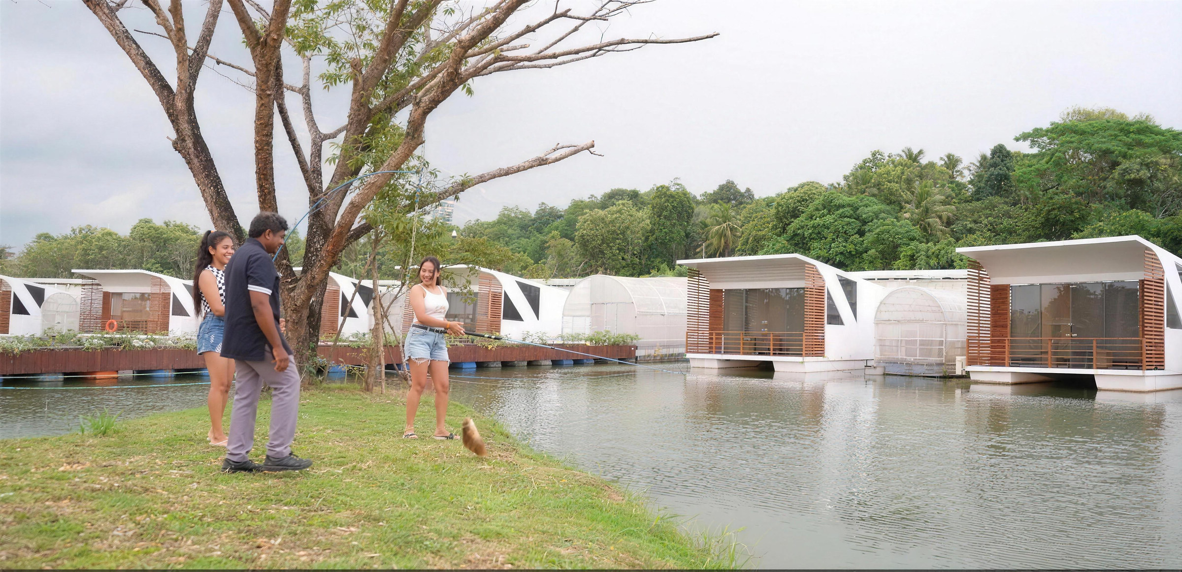 Guests on the lawn beside the floating cabanas