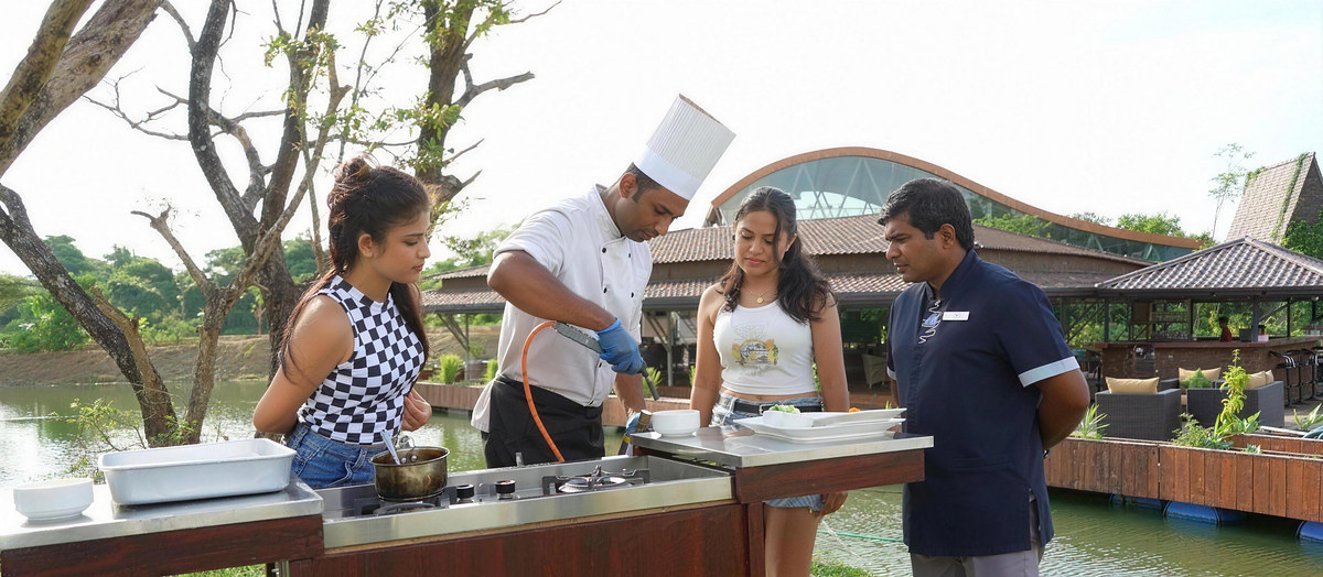 The chef cooks for guests at a lakeside station